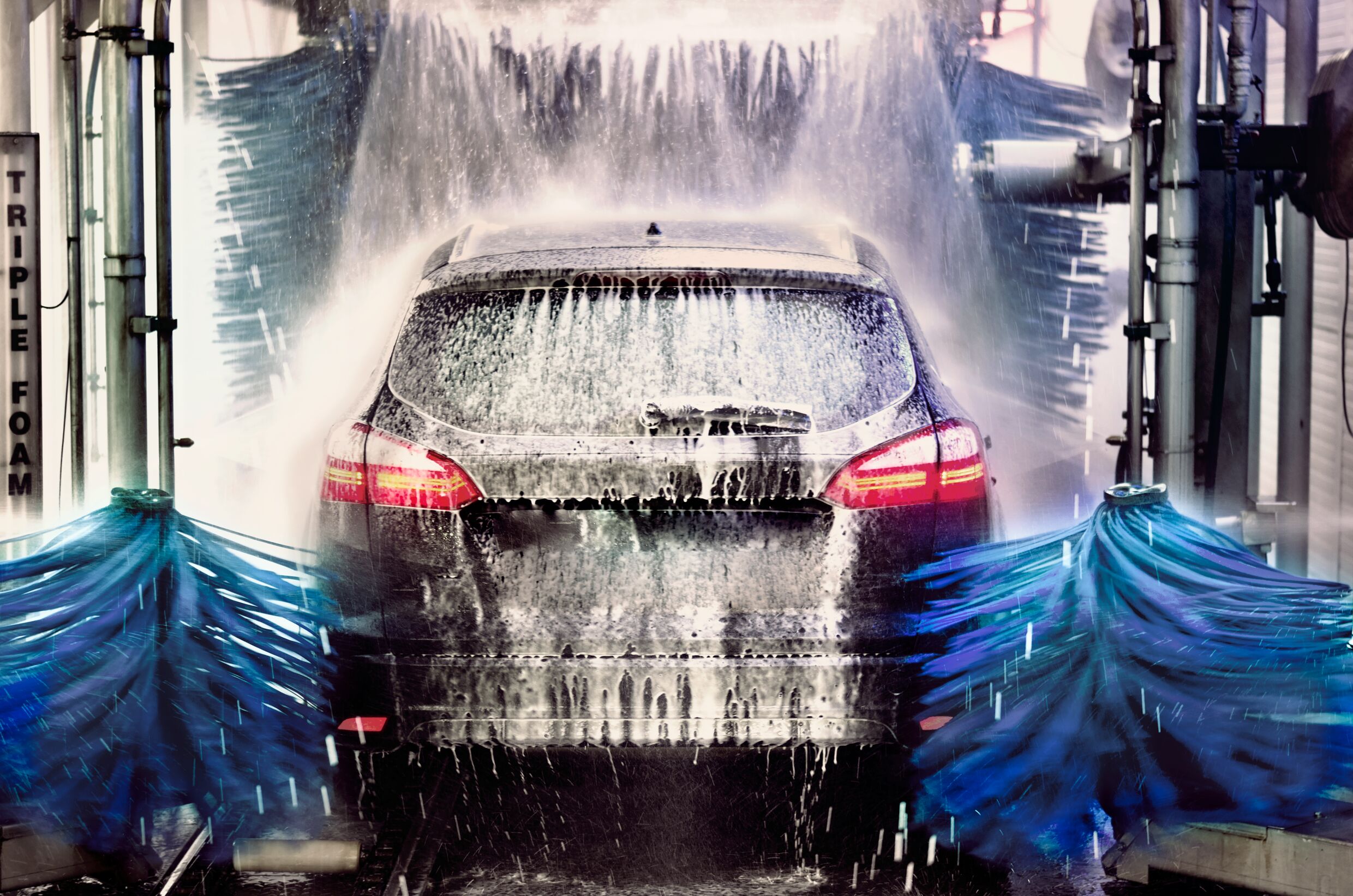 Medium A5 RGB web-Black car being washed in portal washing station.jpg