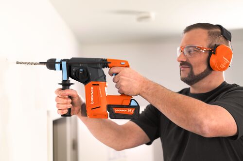 Small STEP RGB Web-HVAC technician drilling in to a wall with a drill bit SDS plus hor.jpg